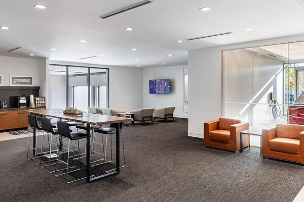 Luxury Cadillac showroom with custom metal panel finishes, specialty lighting, and premium customer experience spaces.