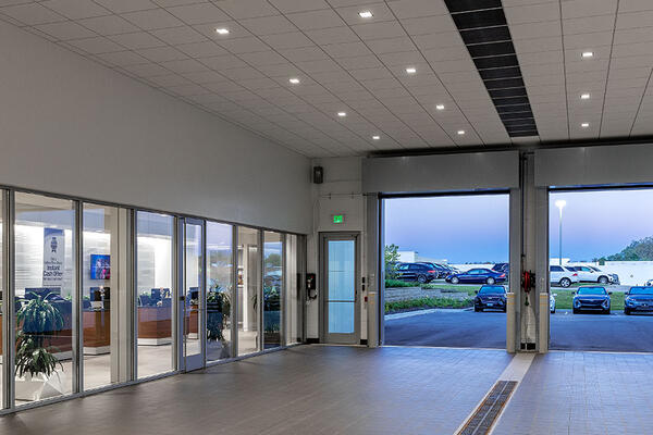 Automotive service center with vehicle maintenance bays, parts storage space, and modern dealership infrastructure.