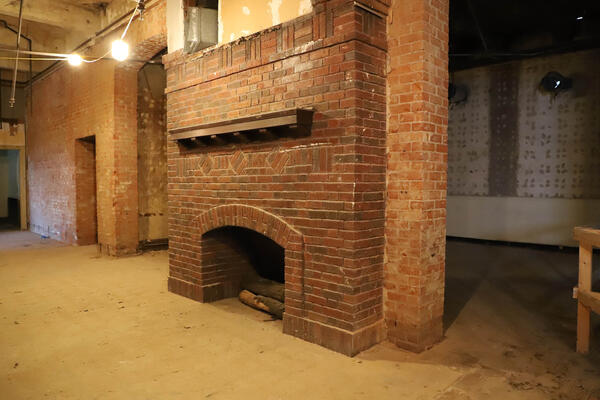Historic fireplace and exposed brick wall