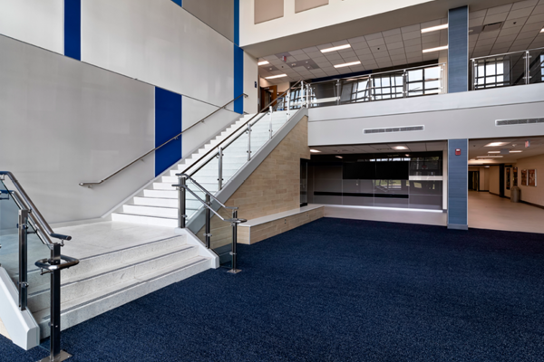A new two-story entrance with a grand staircase welcomes students and staff to the library resource center with business incubators and collaborative spaces.