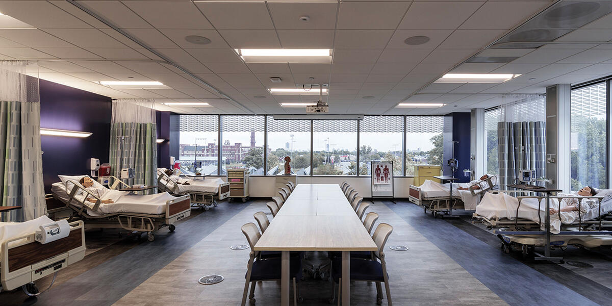 Patient care simulation room equipped with patient dummies on hospital beds 