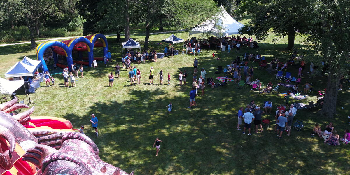 Pepper Picnic attendees enjoying speed pitch, archery, bounce houses and slides at Pepper's Barrington, Illinois office